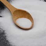 Wooden spoon scooping coarse salt